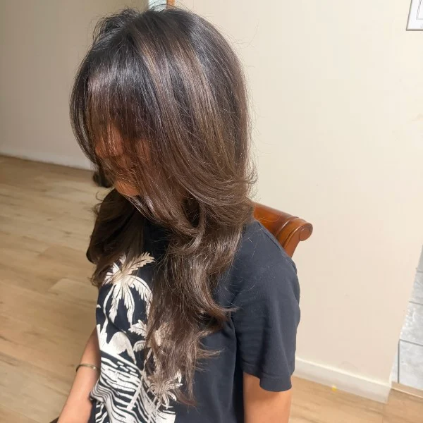 Side view of brown hair with flowing face-framing layers