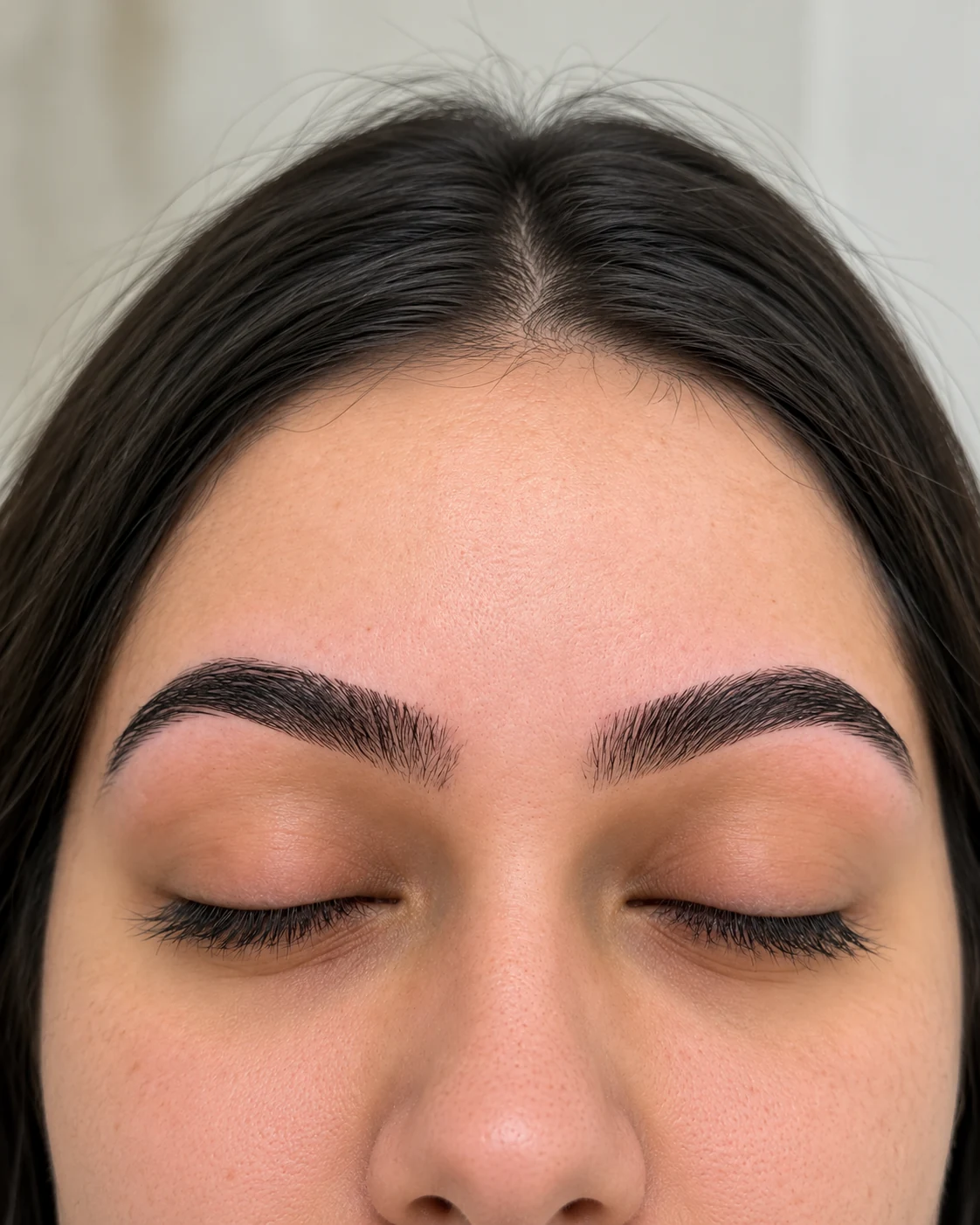 Close-up of shaped eyebrows and closed eyes